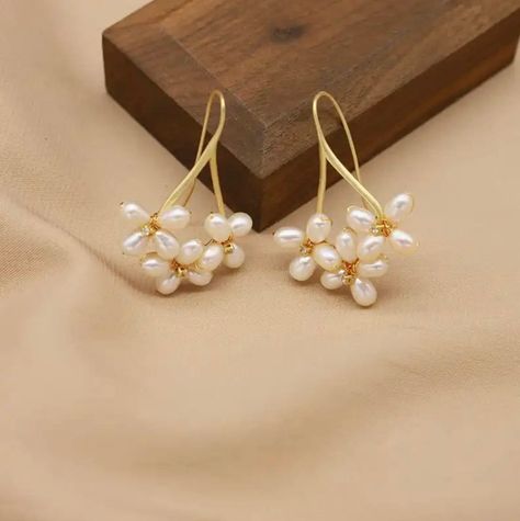 These floral pearl drop earrings are handmade with multiple real AAA quality freshwater pearls and are simply beautiful. The pearls have a smooth, natural white surface that is glowing, and the pearls are designed with a flower-like pattern that encases the pearl and adds a charming touch of beauty. The earrings are delicate, and the white pearls and floral design perfectly complement each other to form an exquisite piece of jewelry. The perfect statement piece for a bride or make them your go-t Bride Earrings Pearl, Pearl Ball Earrings, Unique Pearl Earrings, Flower Pearl Earrings, Handmade Earings, Pearl Earrings Handmade, Earrings Multiple, Real Pearl Earrings, Pearl Cluster Earrings