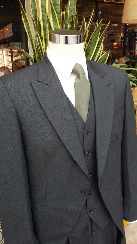 Charcoal grey 3 piece Tailcoat suit with a olive green tie. Tuxedo With Sage Green Tie, Grey Suit Olive Green Tie, Charcoal Suit With Green Tie, Groom Attire Olive Green, Tux With Sage Green Tie, Olive Green Tie Outfit Men, Black Tux With Olive Green Tie, Dark Grey Suit Green Tie Wedding, Gray Suit With Sage Green Tie