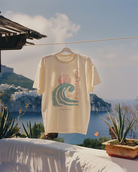 Seize the surf in our Positano 1980 Tee. For the girl who makes waves both on the beach and off, this is your summer statement tee. Unisex soft cotton crew neck t-shirt featuring a Positano Italy Surf Camp graphic printed on the front. Fabrics: 100% cotton, 6 oz Made in: LA Surf Brands Clothing, Surf Merch, Merch Shoot, Summer Graphic Tees, Beach Tshirt, Surf Aesthetic, Beachy Aesthetic, Surf Vibes, Wellness Club