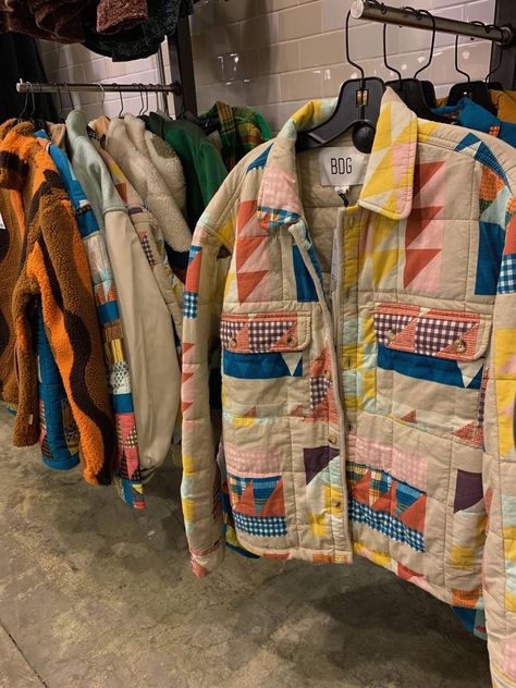 a quilt coat with yellow,blue,pink, gingham and red sections, a little bit oversized hanging on a shirt rack in an urban outfitters store with other similar jackets Quilted Chore Coat, Quilt Coat Outfit, Quilt Cardigan, Quilt Coat Pattern, Quilt Clothing, Quilted Fashion, Fashion Collection Inspiration, Quilted Clothing, Patchwork Fashion