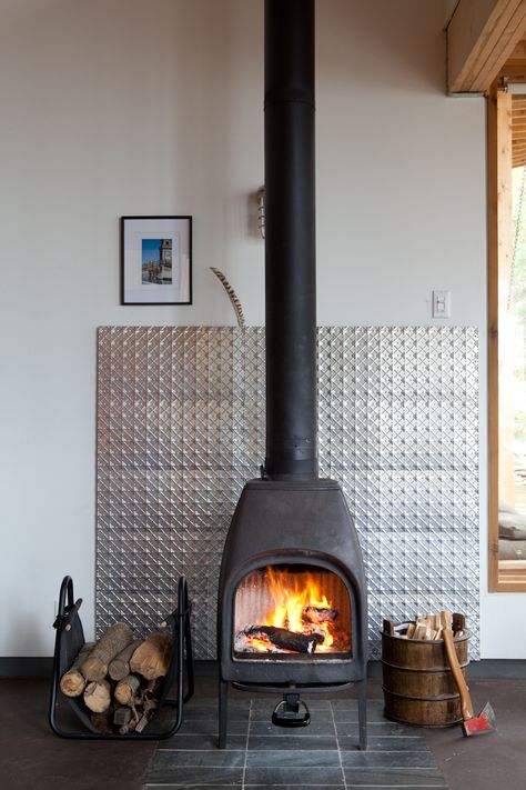 The structures share a solar panel, but the families control their own home's heat level with a wood-burning stove. Wood Stove Surround, Modern Wood Burning Stoves, Wood Stove Fireplace, Into The Wood, Freestanding Fireplace, Log Burner, Stove Fireplace, Post And Beam, Wood Burner