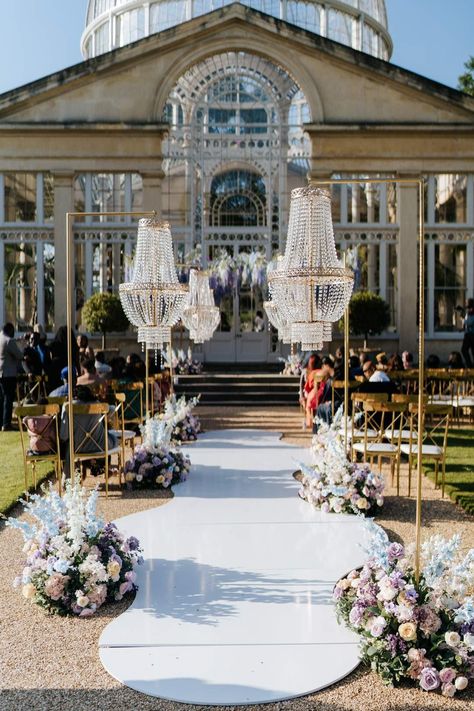 Syon Park wedding venue with outdoor gold and crystal chandeliers and pastel aisle flower arrangements outside of The Great Conservatory for vow renewal Chandelier Wedding Aisle, Chandelier Wedding Backdrop, Wedding Backdrop With Chandelier, Chandelier Outdoor Wedding, Outdoor Chandelier Wedding, Wedding Chandelier Ideas, Wedding Dress Pastel, Chandelier Wedding Decor, Crystal Wedding Decor