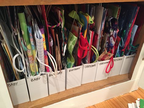 Gift bag storage using IKEA magazine holders. Gift Wrap And Bag Storage, Ikea Bag Holder Hacks, Gift Bag Storage Ideas Diy, Gift Box Storage Ideas, Gift Bags Organization, Christmas Gift Storage, Birthday Bag Storage Ideas, Storage Ideas For Gift Bags, Paper Napkin Storage Ideas