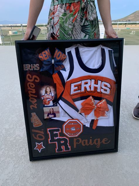 Senior Cheer Boxes Ideas, Senior Cheer Ads From Parents, Framed Cheer Uniform, Cheer Camp Crafts For Kids, Senior Cheer Shadow Box Ideas, Cheer Shout Out Ideas, Cheerleader Shadow Box Ideas, Cheer Wall Ideas, Senior Night Baskets Cheer