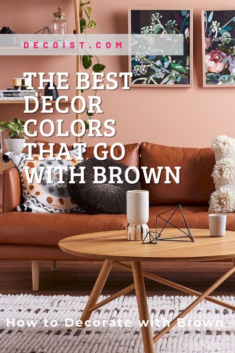 The brown leather couch and wooden furniture pop against the subtle pink wall Pink Living Room Brown Couch, Decorate Brown Leather Couch, Brown Pink Living Room Decor, Living Room With Pink Couch, Brown Leather Couch Office, Pink And Brown Living Room Ideas, Brown And Pink Living Room, Camel Couch Living Room Color Schemes, Pink And Brown Living Room