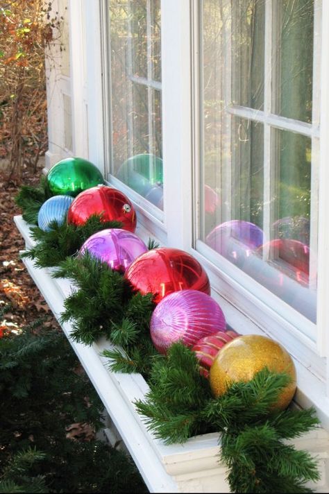 Fill your once blooming flower bed with a handful of brightly colored ornaments instead.  See more at Just*Grand »    - HouseBeautiful.com Best Outdoor Christmas Decorations, Diy Christmas Yard Decorations, Christmas Window Boxes, Christmas Window Decoration, Outside Christmas Decorations, Christmas Window Decorations, Christmas Yard Decorations, Christmas Porch Decor, Christmas Decorations Diy Outdoor