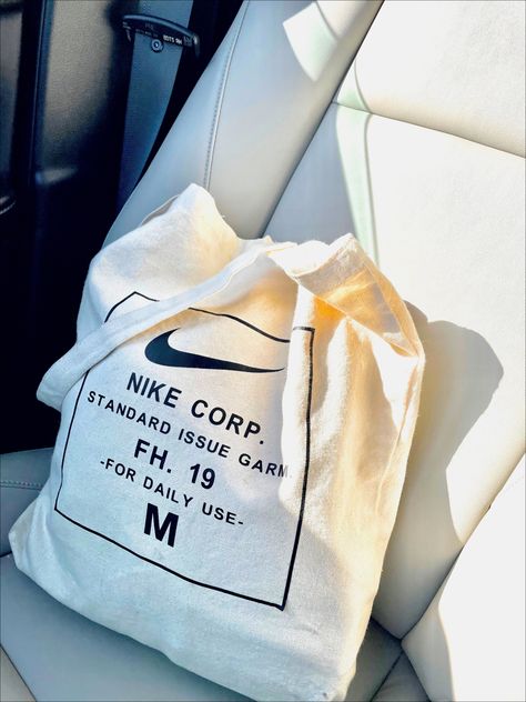 Photo of nike tote bag in the sunlight, aesthetic photo, tote bags, neutral bags, aesthetic photos Nike Tote Bag, Nike Tote Bags, Neutral Bags, Sunlight Aesthetic, Nike Aesthetic, Bag Nike, Neutral Bag, Dog Shop, Bags Aesthetic