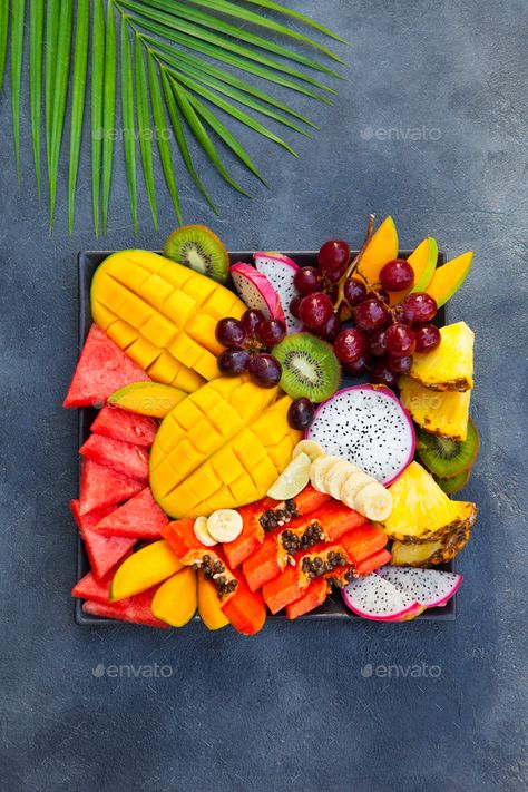 Tropical fruits assortment on a plate. Grey background. Top view. by annapustynnikova. Tropical fruits assortment on a plate. Grey background. Top view. #Sponsored #assortment, #plate, #Tropical, #fruits Fruit Presentation, Fruit Platter Designs, Fruit Creations, Tropical Food, Papaya Fruits, Fruit Decorations, Fruit Box, Fruit Dishes, Fruit Carving