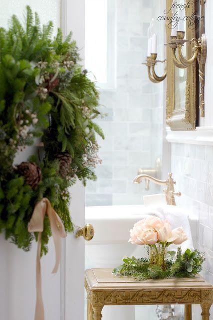 #FrenchCountry decor in this magnificent bathroom decorated for #Christmas! Beautiful wreath on door, gold accents, fresh flowers, marble, and rustic elegance. #holidaydecor French Country Cottage Christmas, Christmas French Country, French Farmhouse Christmas, Country Cottage Christmas, Fresh Garlands, French Country Christmas, French Country Bathroom, Holiday Bathroom, Christmas Vignettes