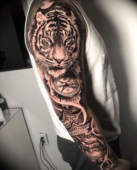 110 Coolest Tiger Tattoo Designs in 2022 - The Trend Spotter Arm Tattoos Tiger, Mens Tiger Tattoo, Tiger Face Tattoo, Tiger Tattoo Sleeve, Arm Sleeve Tattoo, Animal Sleeve Tattoo, Lion Tattoo Sleeves, Tiger Tattoo Design, Men Tattoos Arm Sleeve