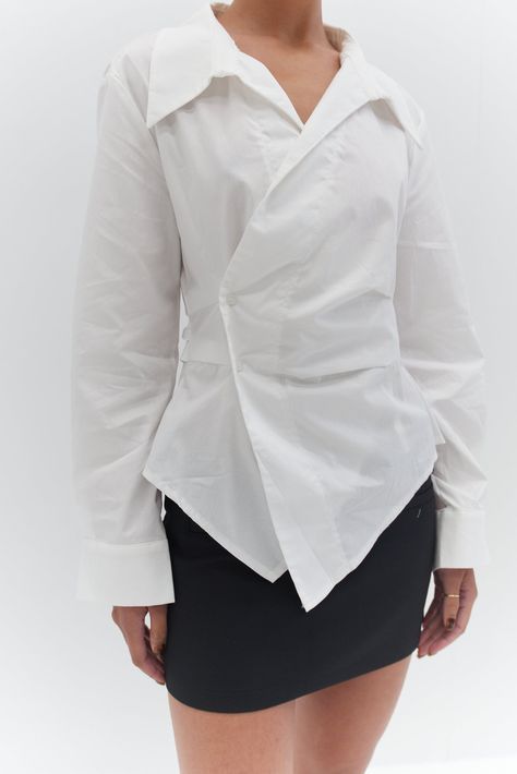 Welcome the Freya Shirt - White - a classic white shirt with a twist. This shirt features a chic button detail at the waist and an asymmetrical front cut Designer White Shirt For Women, Structured Shirts For Women, Fits With White Shirt, Interesting Shirt Designs, Asymmetrical Button Down Shirt, Black And White Classy Outfits, Upcycle Button Down Shirt, White Shirt Design, Shirt Runway