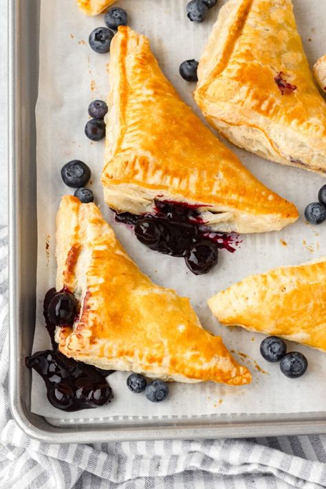 Blueberry turnovers on a sheet pan. Recipe Using Puff Pastry, Turnovers With Puff Pastry, Recipes Using Puff Pastry, Blueberry Turnovers, Using Puff Pastry, Pastry Pie Crust, Pie Crust Cookies, Puff Pastry Shells, Phyllo Recipes