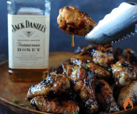 holding wing with tongs with glaze dripping off near bottle of Jack Daniels Honey Jack Daniels Chicken, Tennessee Honey Whiskey, Honey Wings, Jack Daniels Honey, Honey Whiskey, Wing Sauce Recipes, Sweet Savory Recipes, Tennessee Honey, Grilled Chicken Wings