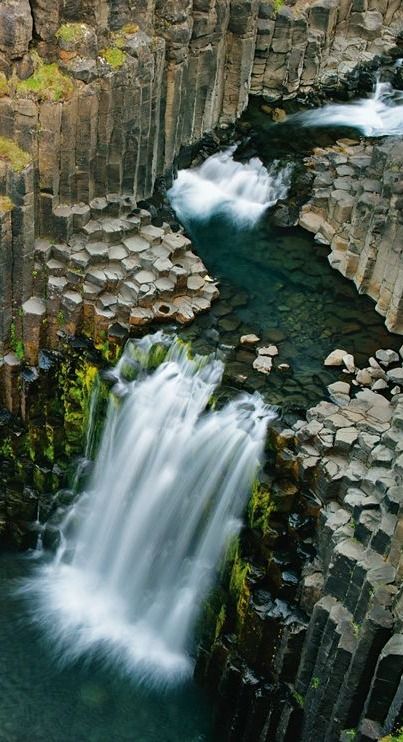 At Litlanesfoss, the waterfall cross-sections an ancient lava flow, which formed columns as it cooled. http://photography.nationalgeographic.com/photography/photo-of-the-day/litlanesfoss-waterfall-iceland/ Iceland Pictures, Phrasal Verbs, Iceland Travel, Beautiful Waterfalls, Pretty Places, Places Around The World, Amazing Nature, Natural Wonders, Beautiful Landscapes