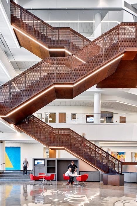 A grand staircase with perforated metal railings zigzags up through the four-storey atrium in a new university building in Kansas by Gensler. Industrial Staircase, Stairs Architecture, Weathering Steel, Interior Design School, Stair Case, Lan Can, Renzo Piano, Modern Stairs, University Of Kansas