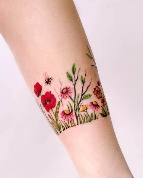 Flower garden bracelet tattoo by @maiko.only Tattoo Flower Bracelet Wrist, Womens Wrist Tattoos Ideas Beautiful, Wildflower Bracelet Tattoo, Wildflower Cuff Tattoo, Birth Flower Arm Band Tattoo, Garden Lover Tattoo, Flower Bracelet Tattoos For Women, Wildflower Band Tattoo, Flower Tatoos Woman Arm