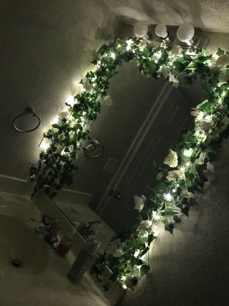 Vine Around Mirror, Mirror With Fairy Lights Around It, Mirror Wall Decor With Flowers, Fairy Lights On Mirror, Vines Over Mirror, Flower Framed Mirror, Fake Vines In Bathroom, Leaves Around Mirror, Vines In Office