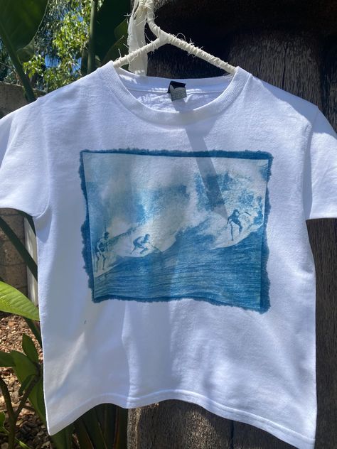 Handmade sun printed surfer t-shirt available as a babytee or regular fit for babytee please select "one size" (fits s/m) also available in regular sizes (s-xl) each shirt is made unique and not all will be the exactly the same but the print will be consistent  Wash instructions - Wash the fabric gently in cold water with a mild, pH-neutral detergent. Avoid using bleach or strong detergents, as they can degrade the print. -Avoid Direct Sunlight: Store the fabric away from direct sunlight when not in use. Prolonged exposure to strong light can cause fading over time. -Dry on cold setting or air dry. Surfer Concert Outfit, Plain Tee Shirts For Women, Side Print Tshirt, Sun Printing Shirt, Cloths Asthetic, T Shirt Aesthetic Outfits, Surf Shirts Graphic Tees, Cyanotype Shirts, Beach Shirt Ideas