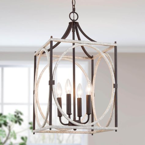 Casually arranged metal straps in industrial-inspired bronze, combined with the sleek polished black frame to form this modern cage chandelier. White Craftsman, Geometric Lantern, Modern Coastal Home, Cage Chandelier, Rustic Lanterns, Cage Light, Lantern Chandelier, Island Pendant Lights, Modern Farmhouse Design