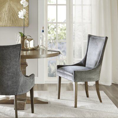 One sure way to add an elegant touch to your dining area while providing some extra seating options is with a 2-piece dining chair set like this one. Designed by skilled craftsmen with a solid and manufactured frame that supports up to 300 lbs., each upholstered chair features a square seat and a clean-lined back with slanted arms. Charcoal grey foam-filled fabric upholstery wraps this design for an understated and inviting feel, while weather-worn wood legs out the look with a touch of antique Table Leg, Grey Dining, Grey Upholstery, Wood Dining Chairs, Upholstered Side Chair, Madison Park, Side Chairs Dining, Upholstered Dining Chairs, Room Table