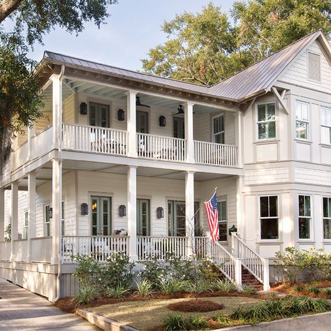 Inside the carefully restored Queen Anne-style Victorian manse PHOTO GALLERY: Queen Anne ReduxDilapidated Victorian houses in Mount Pleasant’s Old Village aren’t as common as they once were, but one 19th-century Venning Street manse seemed destined to slowly rot into ignominy. “It was pretty much a disaster,” says Annie Byrd Hamnett, founder and co-owner of ByrdHouse Public Relations, until she and her husband, Matt, took on the challenge of renovating the home in 2019, blending updated mat Stacked Porches, Queen Anne House, Victorian Exterior, Modern Family Home, Old Village, Colonial Exterior, Old Fireplace, Charleston Homes, Guest Room Office