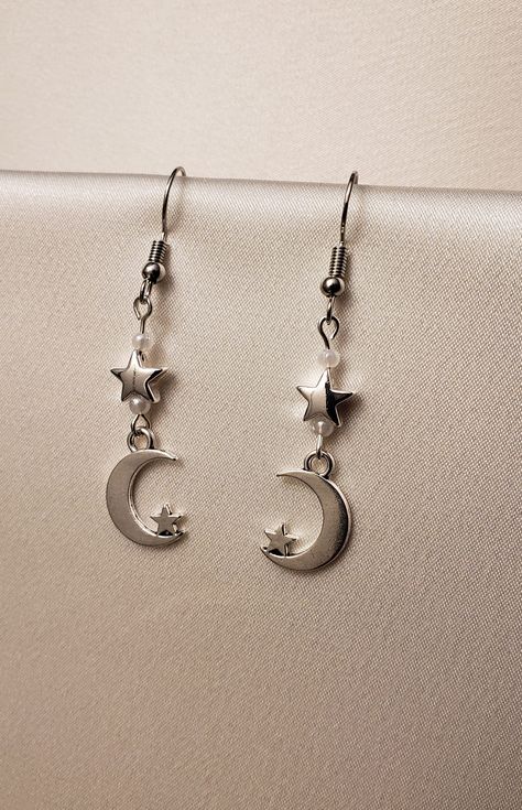 A set of earrings that feature moon and star charms along with small white pearls.  The hooks are made of nickel-free stainless steel. Earrings Aesthetic Silver, Star And Moon Earrings, Moon Earring, Jewelry Accessories Ideas, Funky Jewelry, Drop Beads, Pearl Charms, Jewelry Inspo, Dream Jewelry