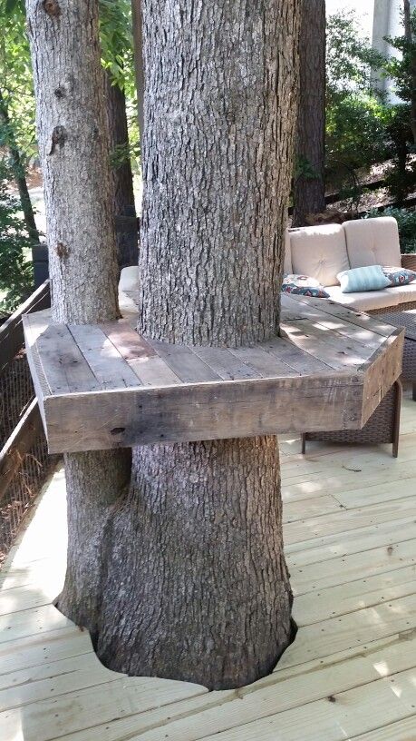 Pallet Tree Bar Using a couple of old pallets I tore down the pallets using all of the wood from the 2x4s to the slats. Connected the structure by using threaded rod and sandwiched the frame around the trunk allowing for growth of the tree. I set Bar top at 40 inches to allow for 2 30 inch outdoor stools. Deck Around Trees, Bench Around Trees, Pallet Tree, Tree Bar, Tree Deck, Popular Woodworking Projects, Tree Bench, Garden Cafe, Recycled Pallets