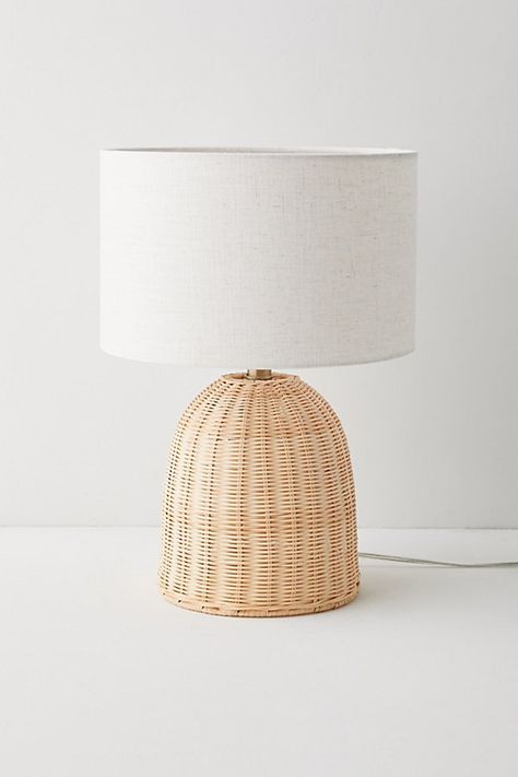 Infuse your space with coastal-meets-cottage flair with this boho table lamp. This table lamp features a dome-shaped base crafted from woven rattan that adds a natural warmth to your space. Topped with a tall, crisp woven drum shade for a chic finish. Features Boho-chic rattan table lamp Plug in Push-through socket switch Compact fluorescent compatible Requires one E26 60W bulb - not included Content + Care 39.6% Rattan, 28.9% packaging, 17.2% fabric, 7.3% electronics, 7% metal Wipe clean Imported Made in compliance with US electrical standards. To use this item outside of the US, pair with an outlet adapter and voltage converter made specifically for use in your location. Size Wattage/Voltage: 60W/120V Dimensions: 12.5" l x 12.5" w x 18.25" h Base dimensions: 7.75" dia x 9" h Shade dimens