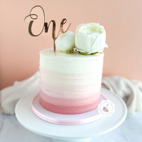 Floral pink ombré cake for celebrating one’s first birthday. #cake #pink #pinkcake #ombrecake #ombre #one #onecake #babycakes #peonies #floralcake Ombre First Birthday Cake, 1st Birthday Cake Flowers, Mauve Birthday Cake, Ombré Pink Cake, Rose Gold Smash Cake, Pink And White Smash Cake, Pink Ombre Smash Cake, White First Birthday Cake, Ombre Cake Pink