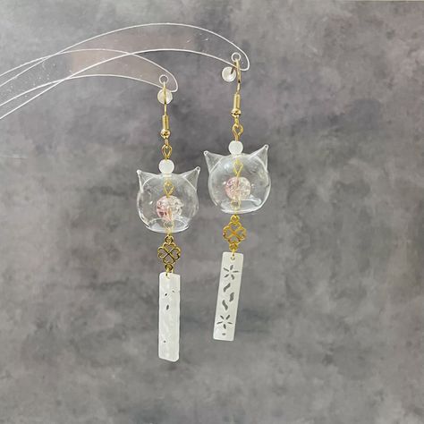 Elevate your style with these handmade earrings - an ideal blend of culture, craftsmanship, and elegance. They're perfect for any occasion!  🤍 The high-quality CAT head shaped glass charm is absolutely adorable, adorned with crackle glass bead and various stunning embellishments, you may choose to have clover charms or not, both designs are absolutely eye catching jewellery!  🤍Two colours available, completed with 18K gold-plated or 925 silver-plated, nickel-free, hypoallergenic earring hooks Chime Earrings, Good Luck Cat, Valentine Jewellery, Valentine Gifts Jewelry, Japanese Gifts, Japanese Cat, Clover Charm, Ear Rings, Valentines Jewelry