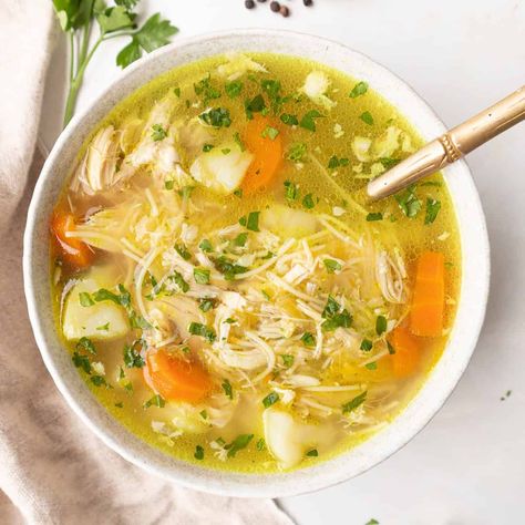 This traditional Spanish chicken soup recipe (sopa de pollo con fideos), it's the ultimate comforting meal that is nourishing, hearty, and delicious. Filled with a rich and aromatic broth, tender chicken, and vegetables, it's ideal for the cooler months, and makes the perfect remedy for sick days. This classic family recipe has been passed through generations, and it's a staple at home. Dominican Chicken Soup Recipes, Spanish Chicken Soup Recipes, Spanish Chicken Soup, Vegetable Paella Recipe, Portuguese Soup, Pollo Recipe, Spanish Chicken, Chicken Soup Recipe, Best Meatballs