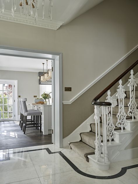 Entrance hall of this beautiful West London townhouse. Marble tile floor with trim, Ornate banister, dado rail, wallpapered walls, view through to bright airy kitchen. Neutral stair runner with dark trim detail. period features Dado Rails In Hallways, Hall Dado Rail Hallways, Dido Rail, Lounge With Dado Rail, Dado Rail Staircase, Stairs Dado Rail, Dado Rail Stairs, Living Room Dado Rail, Hallway With Dado Rail