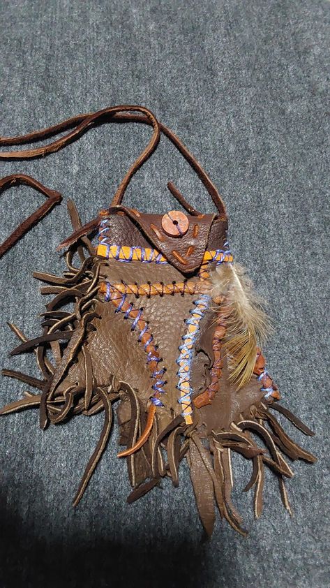 One of a kind abstact art medicine pouch made out of dark brown deer leather with redish brown leather and blue thread accents with a round stone bead. Medicine Bags, Medicine Pouch, North Idaho, Brown Deer, Ren Fest, Fringe Purse, Pouch Purse, Medicine Bag, Deer Skin