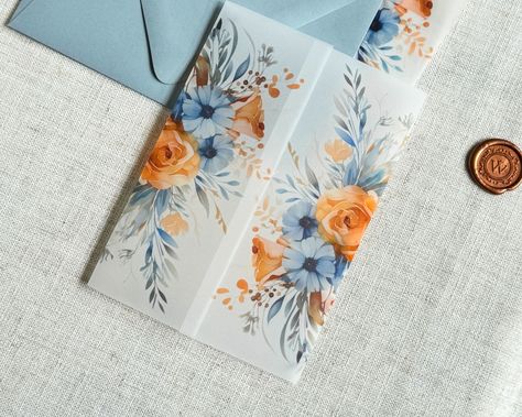 Use these pretty dusty blue and burnt orange watercolor flower vellum Jackets to accessorize your classy wedding invitations!  ------------- DETAILS: Light Weight (30#) or Heavy Weight (42#) Translucent Vellum Jackets Fit 5" x 7" Invitations Ship Flat, Scored or Folded ------------- SPECS ---30# wraps arrive flat, for you to fold them perfectly around your A7 Invitation ---42# wraps arrive scored or folded, for a generic fit Printed with archival, bold inks for a matte, semi-transparent look. Dusty Blue And Amber Wedding, Light Blue And Orange Wedding Theme, Orange And Blue Wedding Invitations, Orange And Dusty Blue Wedding, Light Blue And Orange Wedding, Terracotta And Dusty Blue Wedding, Dusty Blue And Orange Wedding, July Wedding Invitations, Blue And Orange Wedding Theme