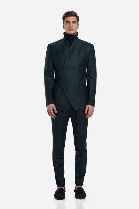 Of Sheer Decadence And Elegance; this multi-angular asymmetrical wrapped bandhgala is punctuated with an angular constructed panel crafted in navy blue suiting. And finished with a half belt closure. The creation is paired with matching straight trousers. Keep styling minimal, think a white turtle neck t-shirt or Orion shirt barely peeking through the bandhgala. Finish with a pair of leather oxfords and sleek pushed back hair #GauravGupta #GauravGuptaMan #GGMan #Bandhgala Asymmetrical Suit Men, Pushed Back Hair, India Fashion Men, Prince Suit, Tshirt Details, White Turtle Neck, Gaurav Gupta, Mens Sherwani, Dress Suits For Men