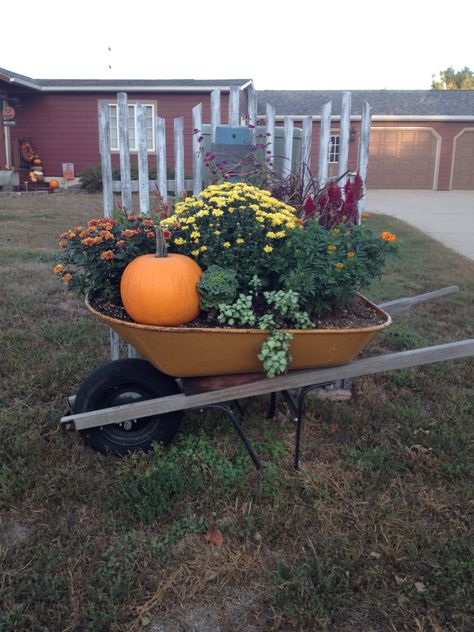 Fall in an old wheelbarrow Wheel Barrow Fall Decor Outdoor, Fall Wheelbarrow Ideas, Wheel Barrow Fall Decor, Autumn Wheelbarrow, Wheelbarrow Planter Ideas, Vintage Wheelbarrow, Mexican Patio Hacienda Style, Goat Cart, Pitch Fork