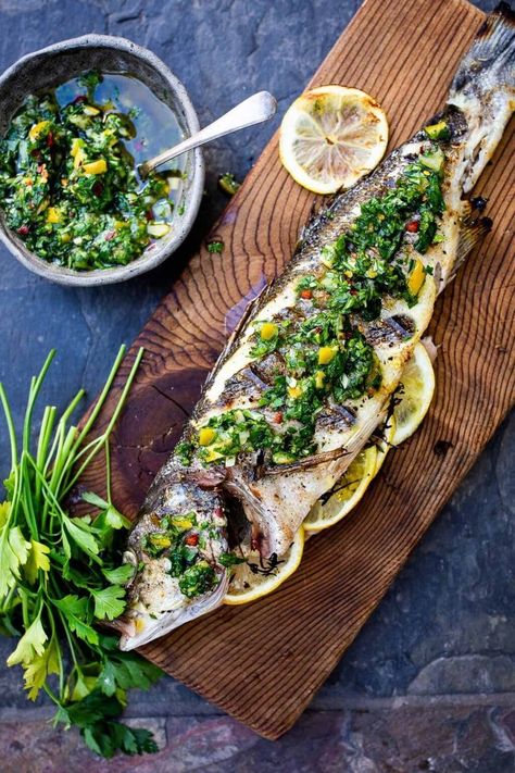 How to grill a whole fish (Branzino) topped with the most flavorful Preserved Lemon Gremolata, (Zesty Herb Sauce) in about 30 minutes flat! A simple easy Mediterranean dinner! #branzino #grilledfish #wholefish #grilledbranzino Lemon Gremolata, Branzino Recipe, Whole Fish Recipes, Gremolata Recipe, Mediterranean Dinner, Clean Eating Guide, Whole Fish, Preserved Lemon, Herb Sauce