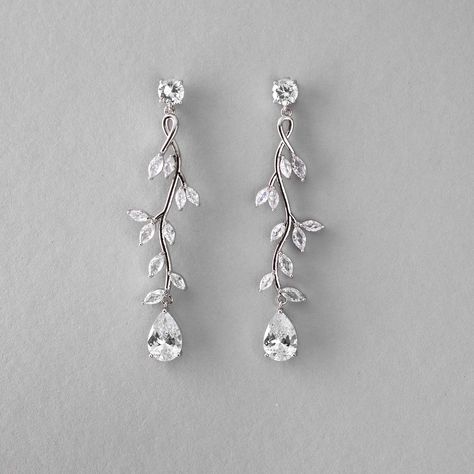 Create a stunning bridal look with our Long Vine CZ Wedding Earrings. These earrings are delicately crafted with a vine of marquise leaves featuring a single pear-cut CZ stone, that adds a touch of elegance to any wedding ensemble. They are about 2.5 inches long, rhodium or gold plated, made with AAA CZ stones, and lead, nickel, and cadmium free. Modern Wedding Earrings Bridal, Fall Wedding Earrings, Dangle Wedding Earrings, Floral Wedding Earrings, Silver Wedding Earrings, Icicle Earrings, Dangly Earrings Silver, Wedding Earrings Bride, Bridal Jewlery