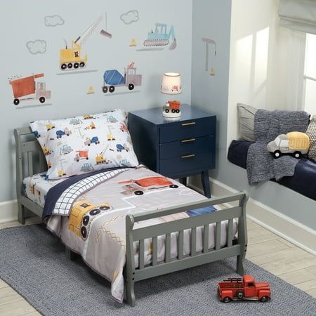 Your little builder will love this fun and colorful 4-piece construction/transportation themed toddler bed set. Included is one quilt 42 cinhes by 57 inches, one top sheet, one fitted sheet, and one standard size pillowcase. Custom designed in vibrant watercolors featuring a variety of construction vehicles. The back of the quilt is a navy blue and white windowpane pattern. The top sheet is navy blue, and the fitted sheet and pillowcase have many different types of construction vehicles. Made in Toddler Construction Bedding, Toddler Boy Room Themes, White Toddler Bed, Construction Bedding, Construction Bedroom, Truck Room, Toddler Boy Room Decor, Boy Toddler Bedroom, Boys Room Design