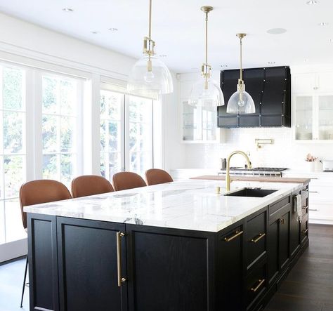 A stunning black oak kitchen island accented with long brass pulls and a white and gray marble countertop is fitted with a stainless steel sink and a brushed gold faucet lit by glass and brass dome pendants. Vermont House, Custom Kitchen Island, Kitchen Post, Black Kitchen Island, Storage Idea, Divine Design, Kitchen Island Design, Transitional Kitchen, Kitchen Inspiration Design