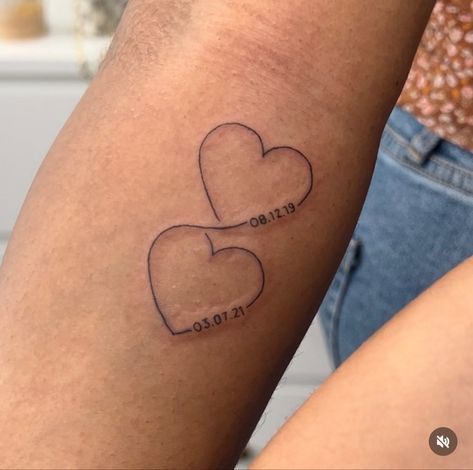 Fine line tattoos with connected hearts. Intertwined hearts with kids birth dates. Birth Year Heart Tattoo, Heart And Year Tattoo, Date Tattoo Ideas Behind Ear, Heart With Birthday Tattoo, 2 Dates Tattoo, Two Hearts Connected Tattoo, Tattoos Dates Of Birth, Tattoo Ideas Date Of Birth, Hearts With Names Tattoos