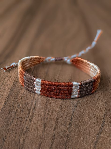 Handwoven bracelet made by using natural cotton thread in terracotta colors with beads. The warp yarn is linen. These handwoven accessorie is a combination of old traditions with a modern vision. All bracelets are in limited quantities.  Every bracelet is made with adjustable makrame slipknot closure in order to fit on any wrist. It is light and comfortable to wear. You can combine it with any other bracelets or different materials of you jewelry. * Width: 1,3 cm Woven Length: 15,5 cm * Closure:  Makrame slide lock * Adjustable * Color: White, terracotta Packaging of your orders is  in the last photo. If you have a questions or special wishes I'll be happy to help you. More of my handwoven bracelets: https://www.etsy.com/shop/KryzhovaHandmade?ref=profile_header&section_id=43842133 Macrame Bracelet Tutorial, Fabric Tapestry, Handwoven Tapestry, Pola Gelang, Hippie Bracelets, Gift Best Friend, Bracelet Knots, Hand Woven Textiles, Friend Gifts