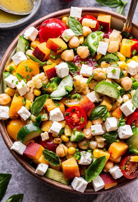 This Summer Chickpea Salad is loaded with summer's finest produce. Hearty chickpeas, corn, cucumbers, tomatoes, peaches, feta and fresh basil are all tossed in a fresh and tangy lemon vinaigrette. Serve it as a vegetarian main dish or side dish this summer! #chickpeas #chickpeasalad #summersalad #saladrecipes #vegetarian #salad #sidedish Moroccan Chickpea Salad, Gf Salads, Chickpea Salad Vegan, Recipe Runner, Chickpea Tuna Salad, Greek Chickpea Salad, Greek Chickpeas, Vegetarian Salad, Fresh Summer Salad