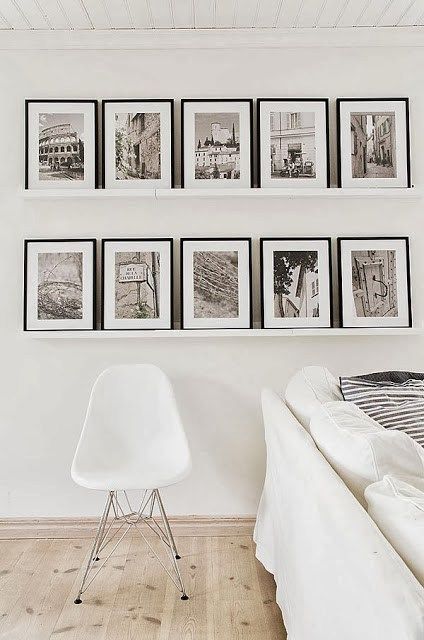 A touch of black in the form of framed black and white photos on the floating shelves adds just the right amount of contrast. Scandinavian Country Style, Travel Photos Display, Diy Home Decor For Apartments, Creative Wall Decor, Photo Wall Gallery, Dekor Diy, White Living, White Living Room, Hang On