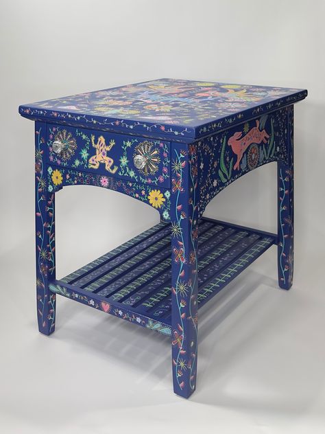 Solid wood side coffee table with drawer. Quality construction and hand painted to last for generations. Finished with Polycrylic for many years of use. Beautiful rabbits, frogs and birds are painted on the surface of the table with flowers spread throughout the item.