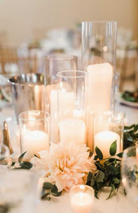 You’ve probably decided what your wedding theme is. Wedding reception centerpieces should be beautiful, but they don’t have to be difficult. There’s no need... Candles And Flowers, White Centerpiece, Tafel Decor, Candle Wedding Centerpieces, Elegant Candles, Wedding Reception Centerpieces, Wedding Floral Centerpieces, Reception Centerpieces, Wedding Table Plan