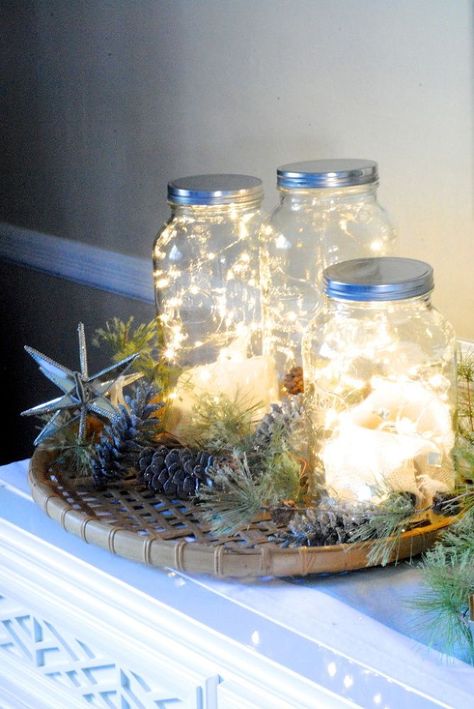 Simply fill a Mason jar with a bunch of string lights, then cluster together on a mantel or entryway table. Beautiful! Fairy Lights In A Jar, Decor Shabby Chic, Christmas Mason Jars, Christmas Jars, Decoration Originale, Jar Lights, Noel Christmas, Mason Jar Diy, Mason Jar Crafts