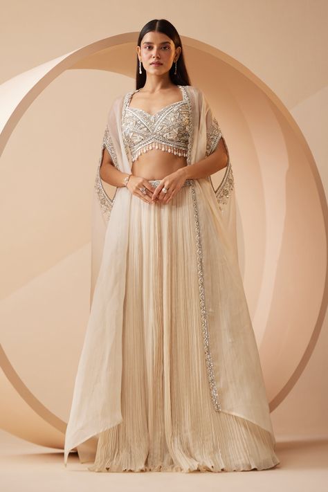 Buy Off White Blouse And Lehenga Modal Satin Abida Pearl Border Cape Set For Women by Roqa Online at Aza Fashions. Trendy Lehenga Blouse Designs, Lehenga Designs For Teens, Indian Designer Suits Party Wear, Lengha Ideas, Sangeet Dress, Pearl Border, Jacket Lehenga, Cutdana Embroidery, Cancan Lehenga