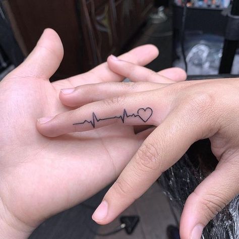 Top 24 Fingers Heart Tattoos To Must Try In 2024 Heartbeat Tattoo On Finger, Heartbeat Finger Tattoo, Nurse Finger Tattoo, Inside Finger Tattoo For Women, Last Heartbeat Tattoo, Finger Tattoos For Women Unique, Heartbeat Tattoo Ideas, Tattoo Heartbeat, Finger Tattoos Fade