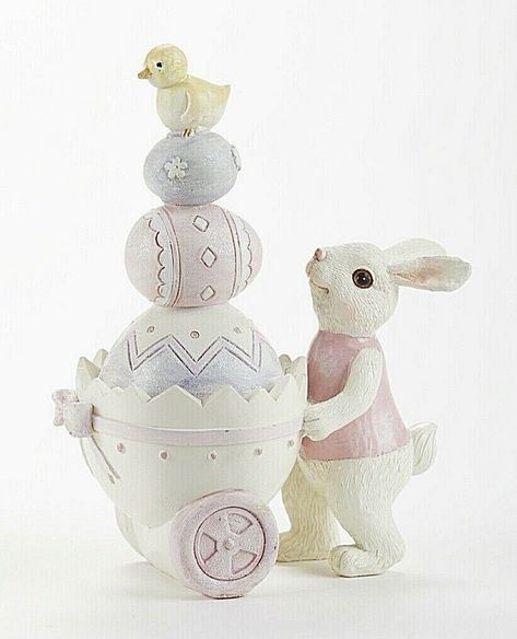 "Welcome to The Primitive Pineapple Collection. Welcome to The Primitive Pineapple Collection. This charming bunny as a cart full of Easter's Best. This resin bunny is 4.3\" x 5.7\" and is in a lovely pastel hue. Makes a great addition to any home www.primitivepineapplecollection.com * This charming bunny as a cart full of Easter's Best. This resin bunny is 4.3\" x 5.7\" and is in a lovely pastel hue. This little guy is hand painted. Makes a great addition to any home WWW.PRIMITIVEPINEAPPLECOLLE Country Spring, Spring Bunnies, I Love My Grandma, Picked Flowers, Simmering Potpourri, Easter Wood Crafts, Bunny Egg, Spring Bunny, Spring Pastels